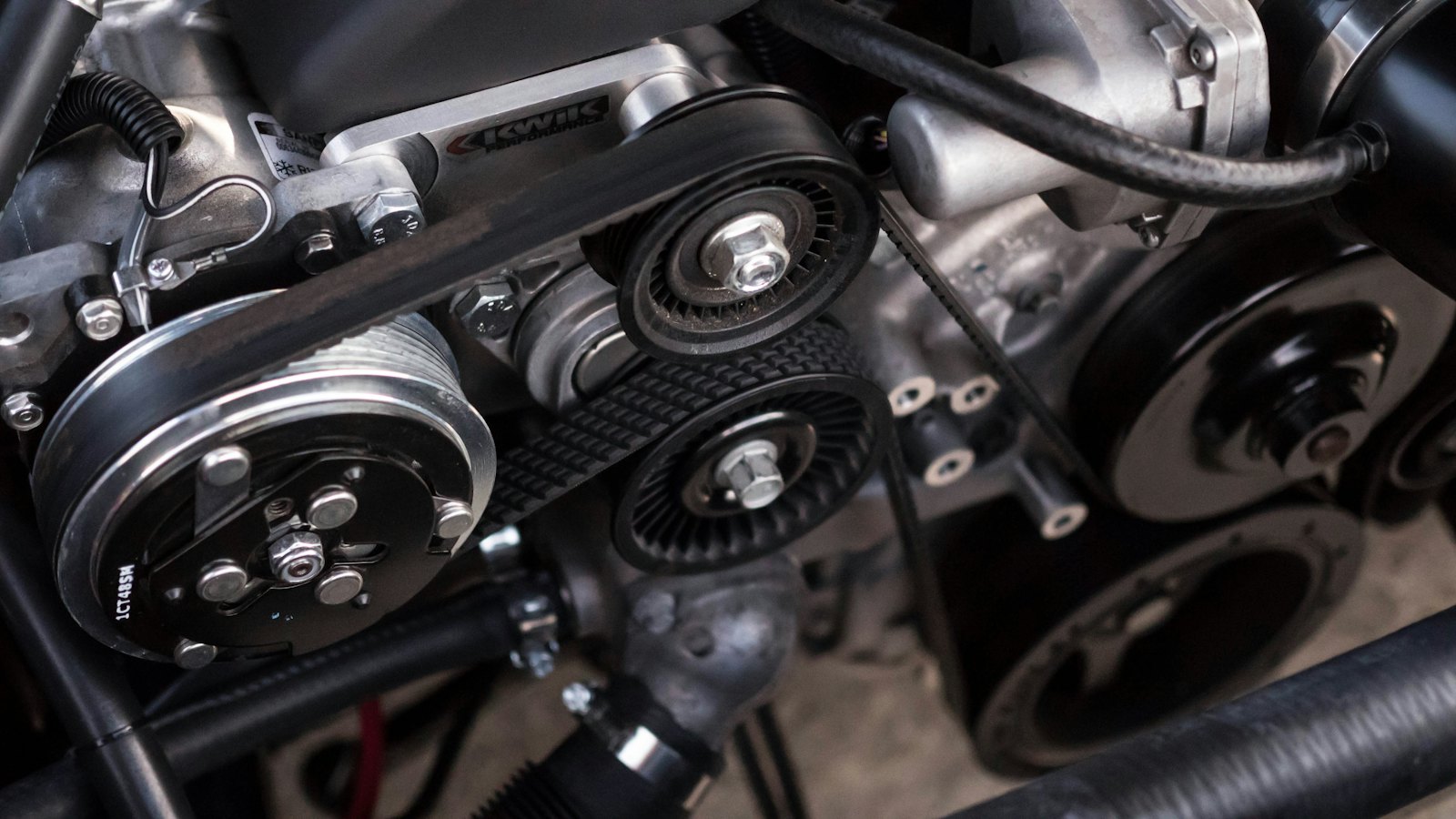 Close-up of an engine&rsquo;s belts and pulleys